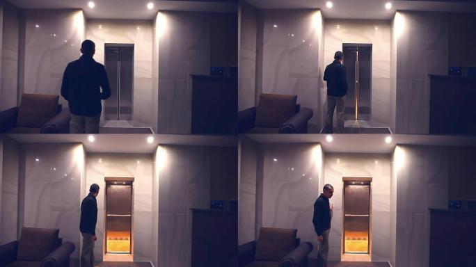 男人晚上可以坐下来，打开酒店大楼的电梯