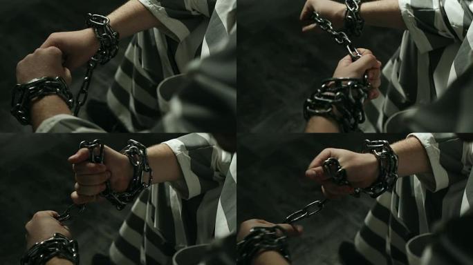 双手被锁链的囚犯