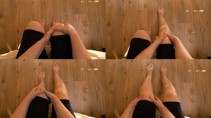 女人坐在床上按摩双膝关节疼痛的观点