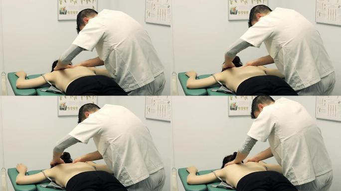 治疗师正在按摩年轻患者的肩膀和脖子; 按摩，背部。