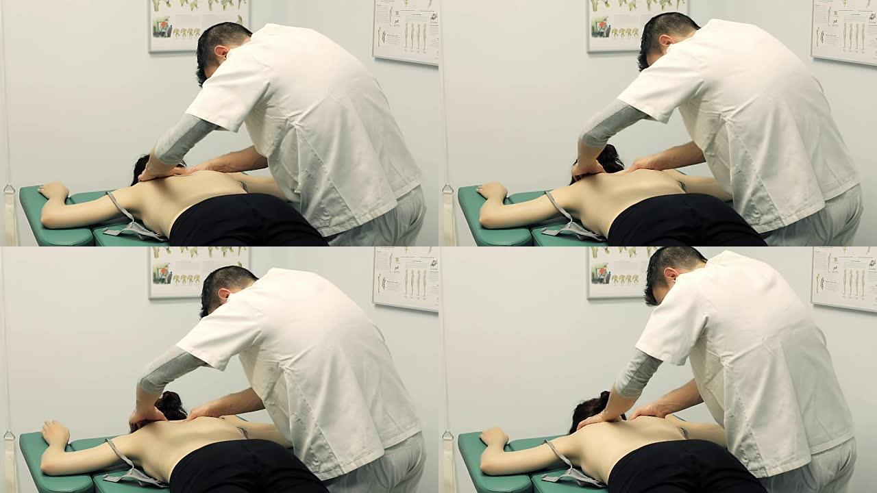 治疗师正在按摩年轻患者的肩膀和脖子; 按摩，背部。