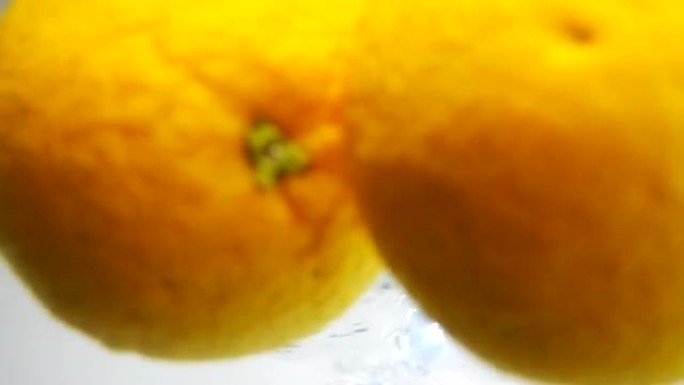 两个橙子半掉入水中
