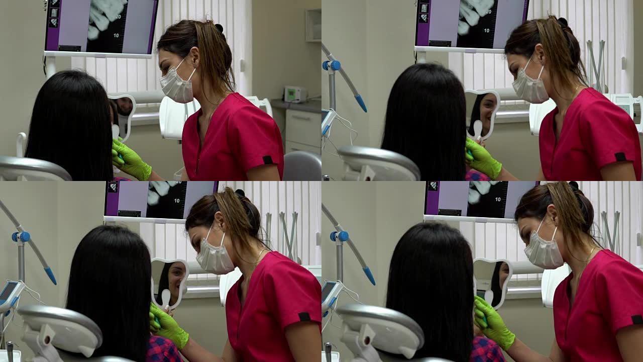 牙医在解释治疗时，病人正在照镜子。年轻的女牙医正在检查病人。4k拍摄