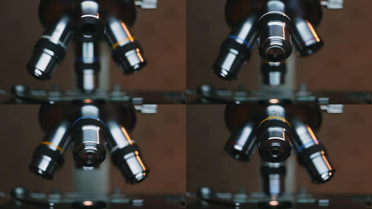 手科学家调整显微镜的目镜。