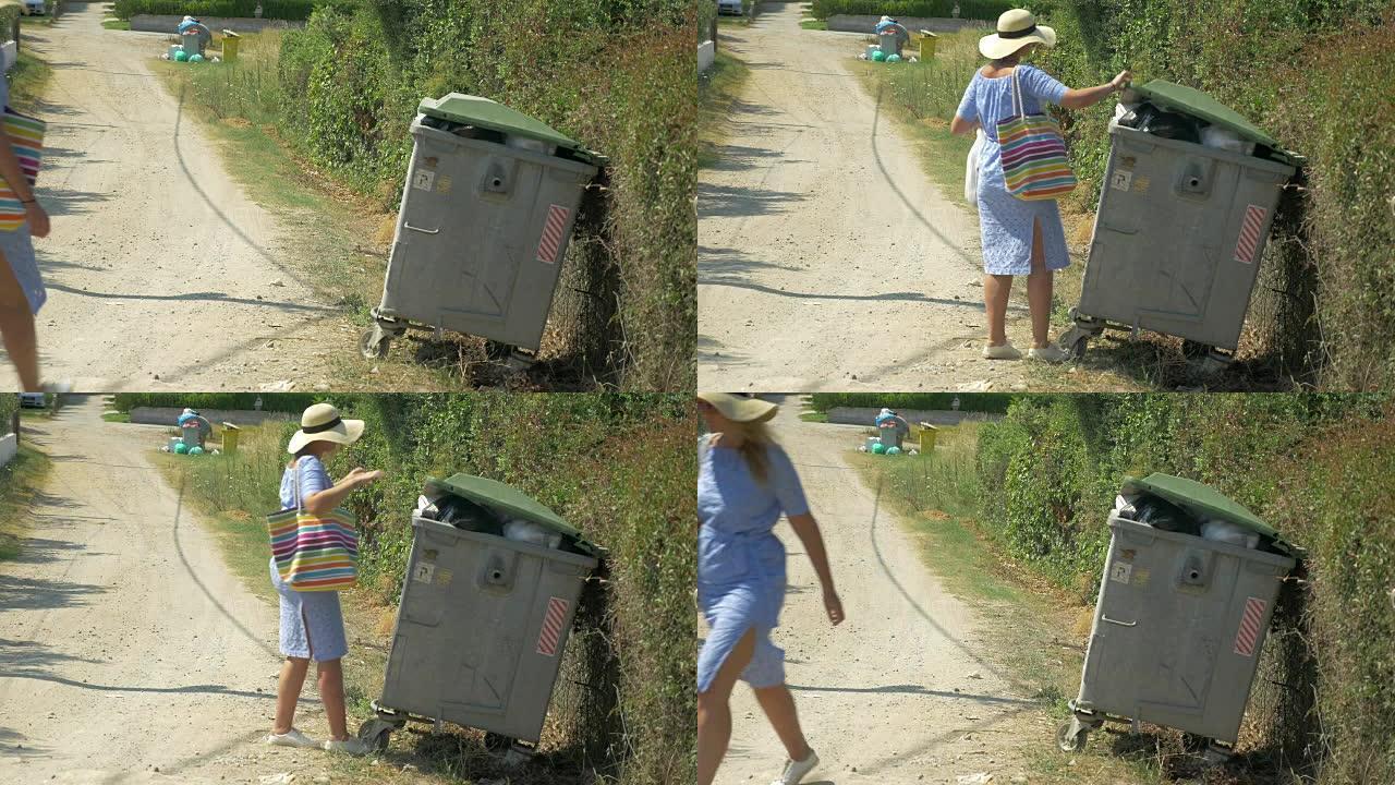 女人把垃圾带到街头集装箱里