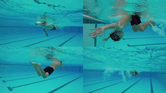 年轻的亚洲男孩自由式游泳并翻滚