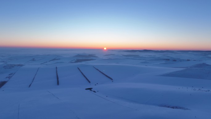 航拍4K东北垦区田野雪景落日