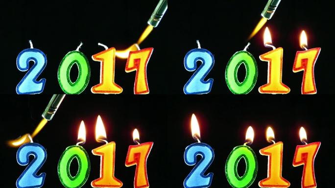 火炬火焰点燃数字形状的蜡烛，庆祝新年2017到来，隔离在黑色背景下