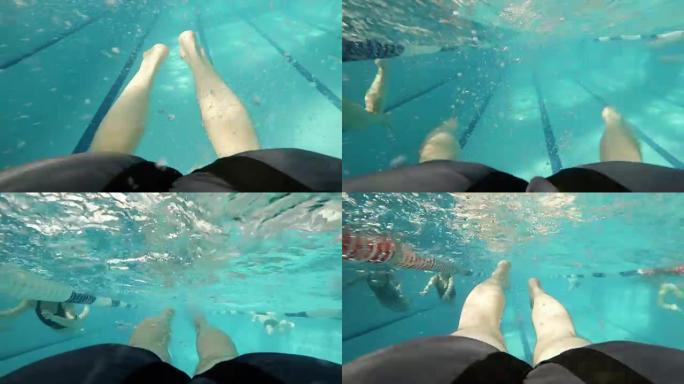 蛙泳: 游泳者在游泳池里的腿