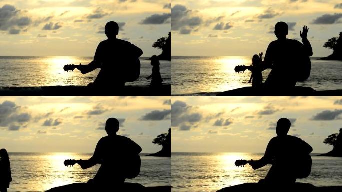 日落海滩上向年轻女士弹奏吉他的男子剪影