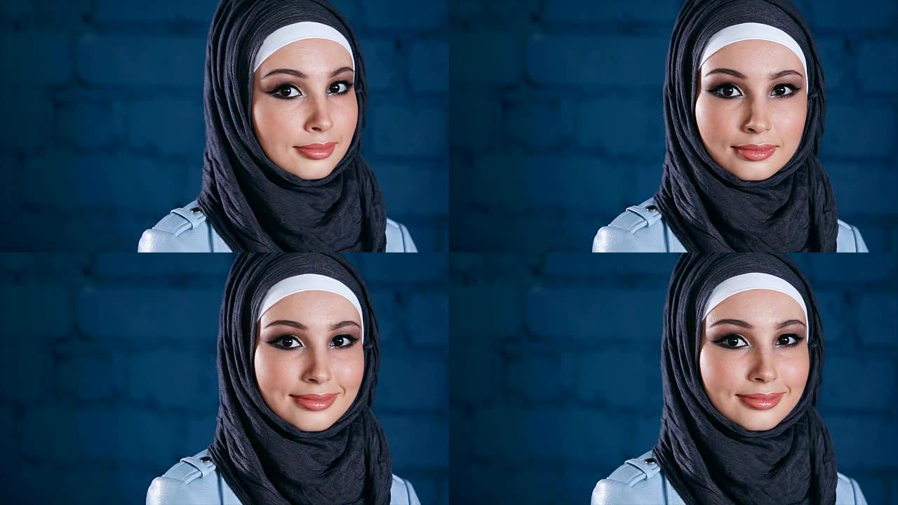 穿着黑色头巾的年轻穆斯林妇女。室内肖像