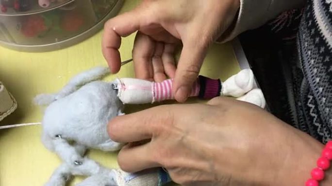 木偶大师为洋娃娃制作鞋子和衣服。