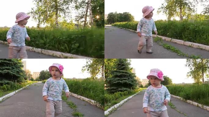 小女孩微笑着在公园的小巷里奔跑。