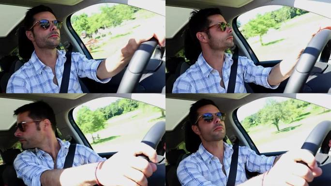 英俊的男人随便开车。在高速公路上放松的司机。假日旅行的人。戴墨镜的男子自然驾驶