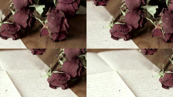 复古背景，褪色玫瑰花束和旧手写信件