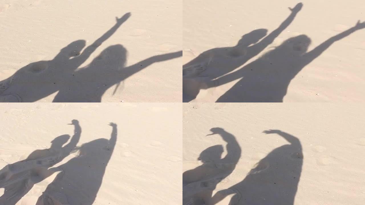 沙滩上跳舞的阴影