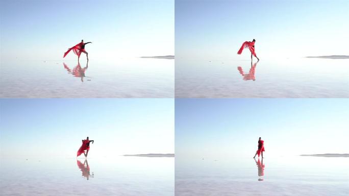 美丽的芭蕾舞演员在湖上跳舞，穿着红色薄纱