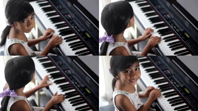 亚洲女孩学习弹钢琴