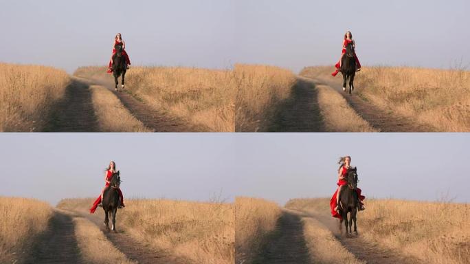 穿着红色长裙的年轻女孩在干燥的草原上骑着黑马