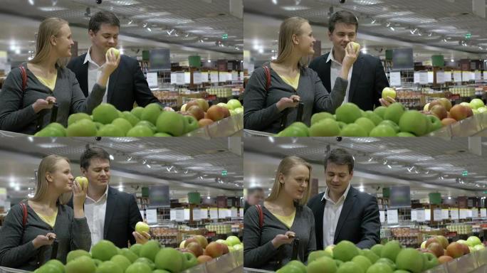 夫妇在杂货店选择苹果
