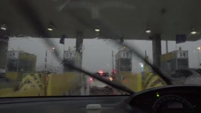 暴风雨期间，雨水在向高速公路收费时溅出了汽车挡风玻璃