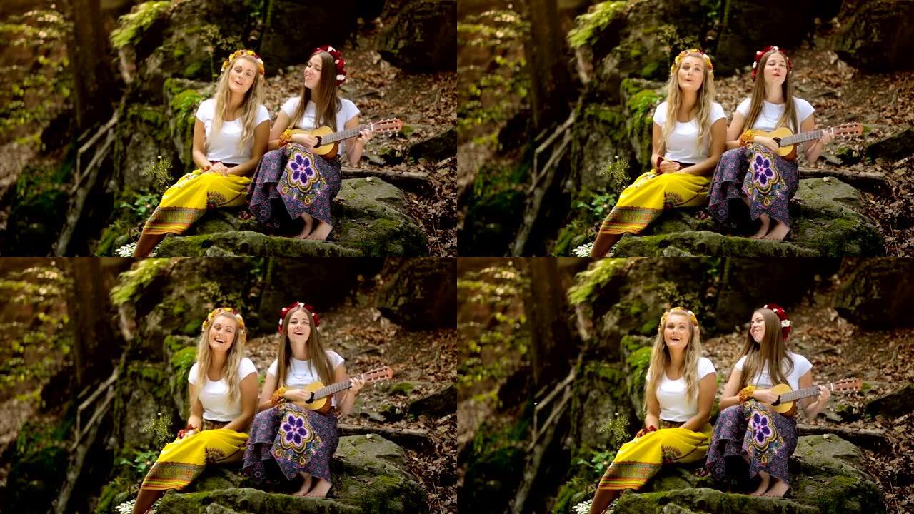 两个年轻女孩在夏天的森林里拿着吉他
