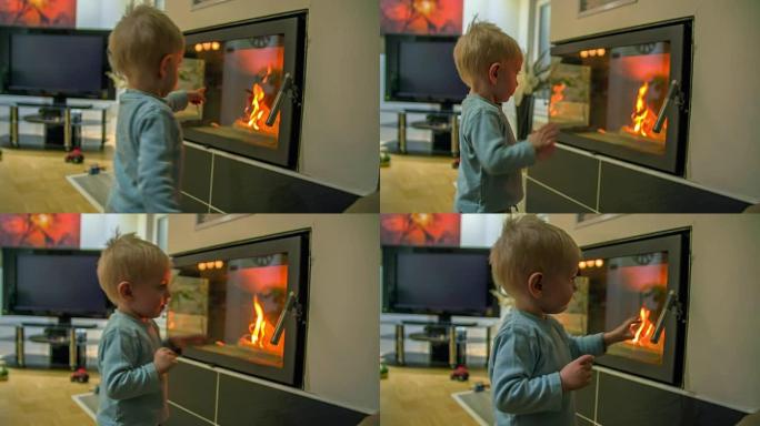 一个小男孩指着壁炉里的东西