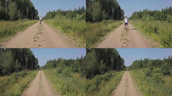 摄像机聚焦在森林路上的徒步旅行者上