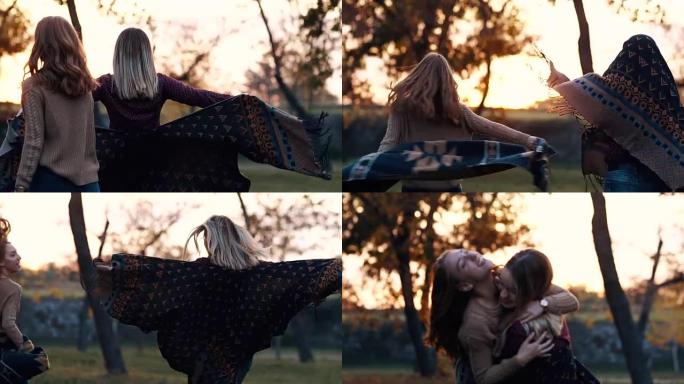 两名年轻女子在秋天的日落时拥抱
