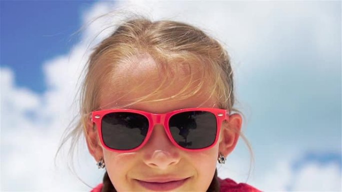 暑假期间海滩上可爱的小女孩的肖像。慢动作