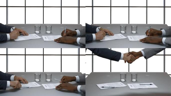 商人在大窗户的背景上签订合同。