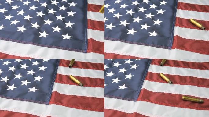 在慢动作中掉落在美国国旗上的子弹壳的平移镜头