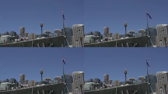 一艘带有澳大利亚国旗的大型海洋船的前部，背景是悉尼塔和天际线
