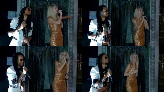 二重唱非裔美国男人和一个金发女人唱歌。慢动作