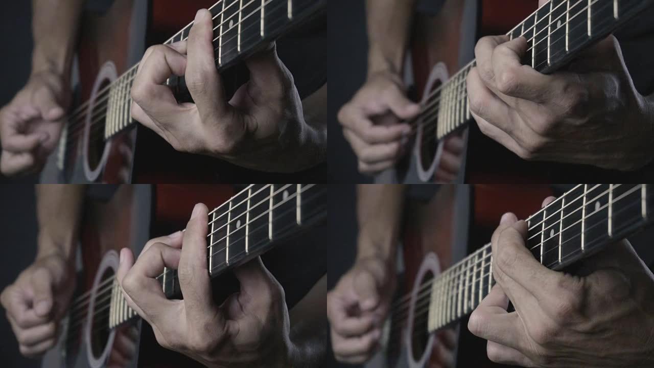 男子在黑色背景上弹奏木吉他，手指慢动作