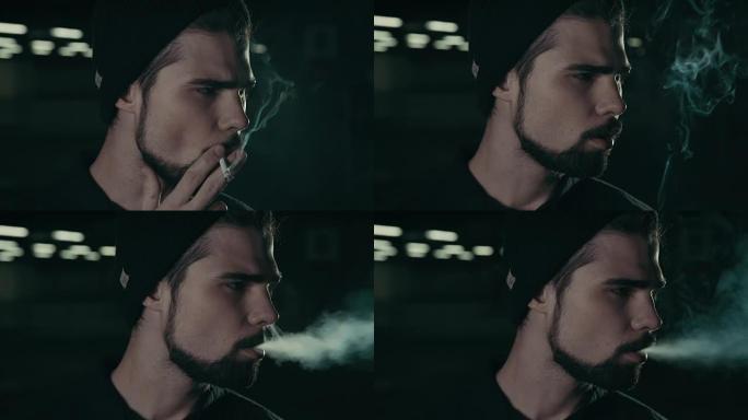 年轻英俊的大胡子潮人抽烟