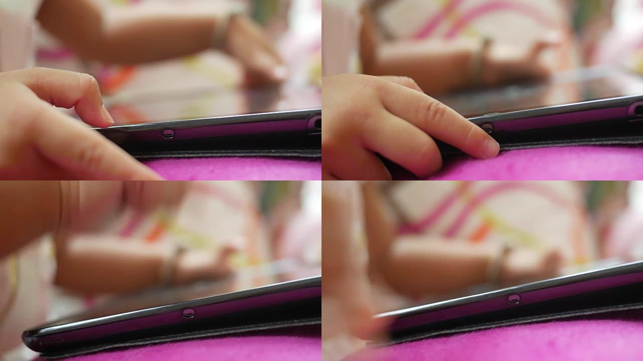 使用数字平板电脑的小女孩的特写手指
