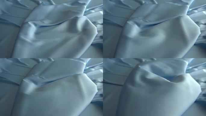 背景纹理柔软的蓝色织物纺织材料反向移动。