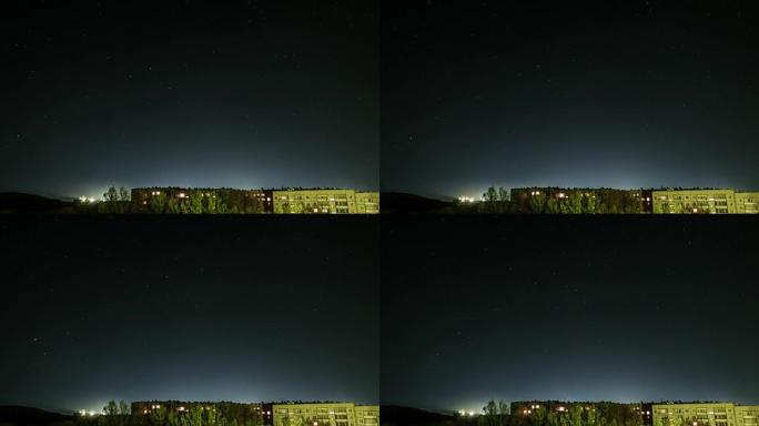 星空在房屋背景下的时间表，窗户上的灯光亮着。哈萨克斯坦塞米巴拉金斯克