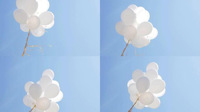 蓝天中膨胀的白色氦气球