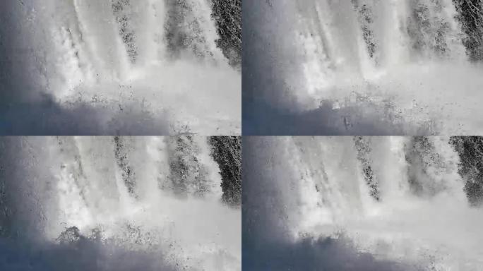 特写: 强大的汹涌白水瀑布坠落。清澈的冰川水流滴落。50fps