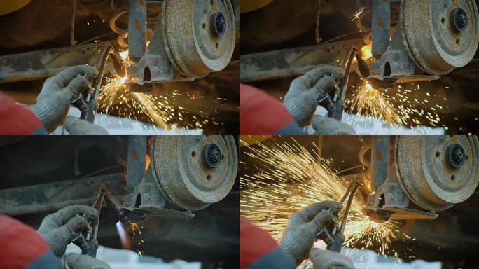 轮胎更换手的特写镜头使用保加利亚人以利用生锈的机器的细节，火花从仪器上飞出