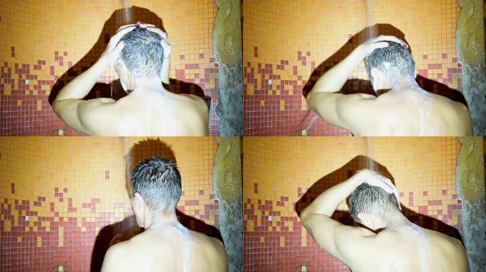 一个有魅力的男人在淋浴时洗澡。