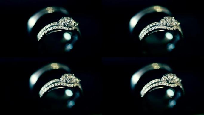 微距在黑暗中拍摄结婚戒指。婚礼主题。