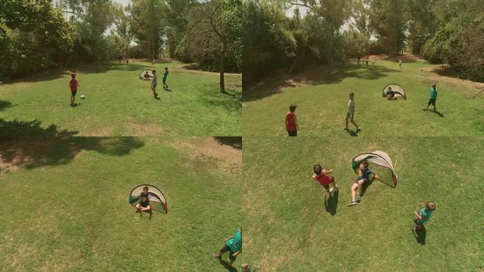 夏令营中快乐的年轻孩子在绿草地上踢足球儿童慢动作空中垂直