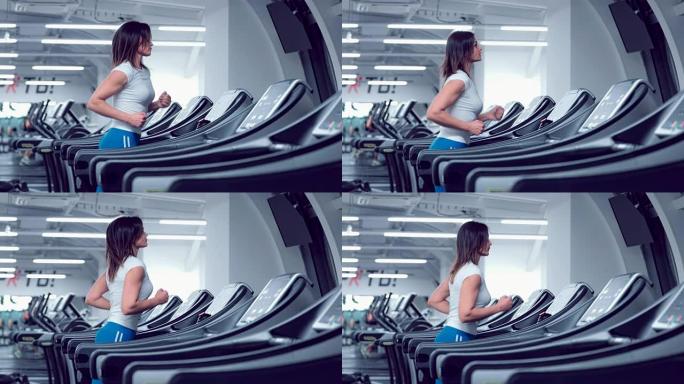 Adult woman runs on treadmill at the fitness centr