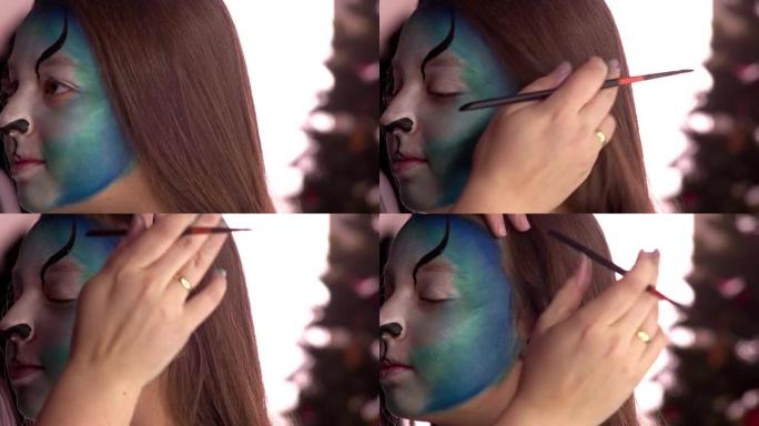 Close-up of a girl having face painted on a party