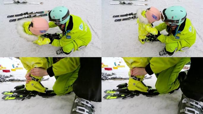 教练帮助给婴儿穿滑雪板。