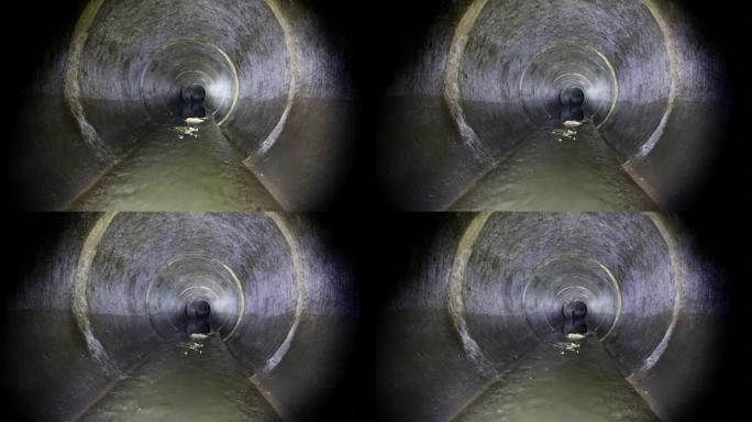 黑暗的地下下水道圆形混凝土隧道。工业废水和城市污水流抛污水管