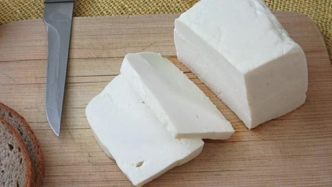 Goat cheese on a wooden cutting board